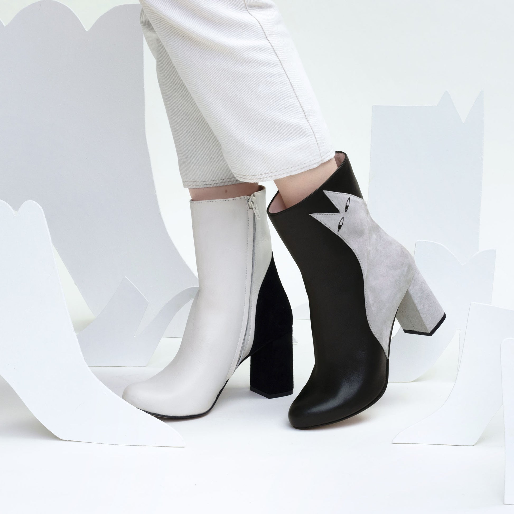 Product shot of the iconic Ziggy and Etta high heeled boots being modelled in illustrative white shoe set.