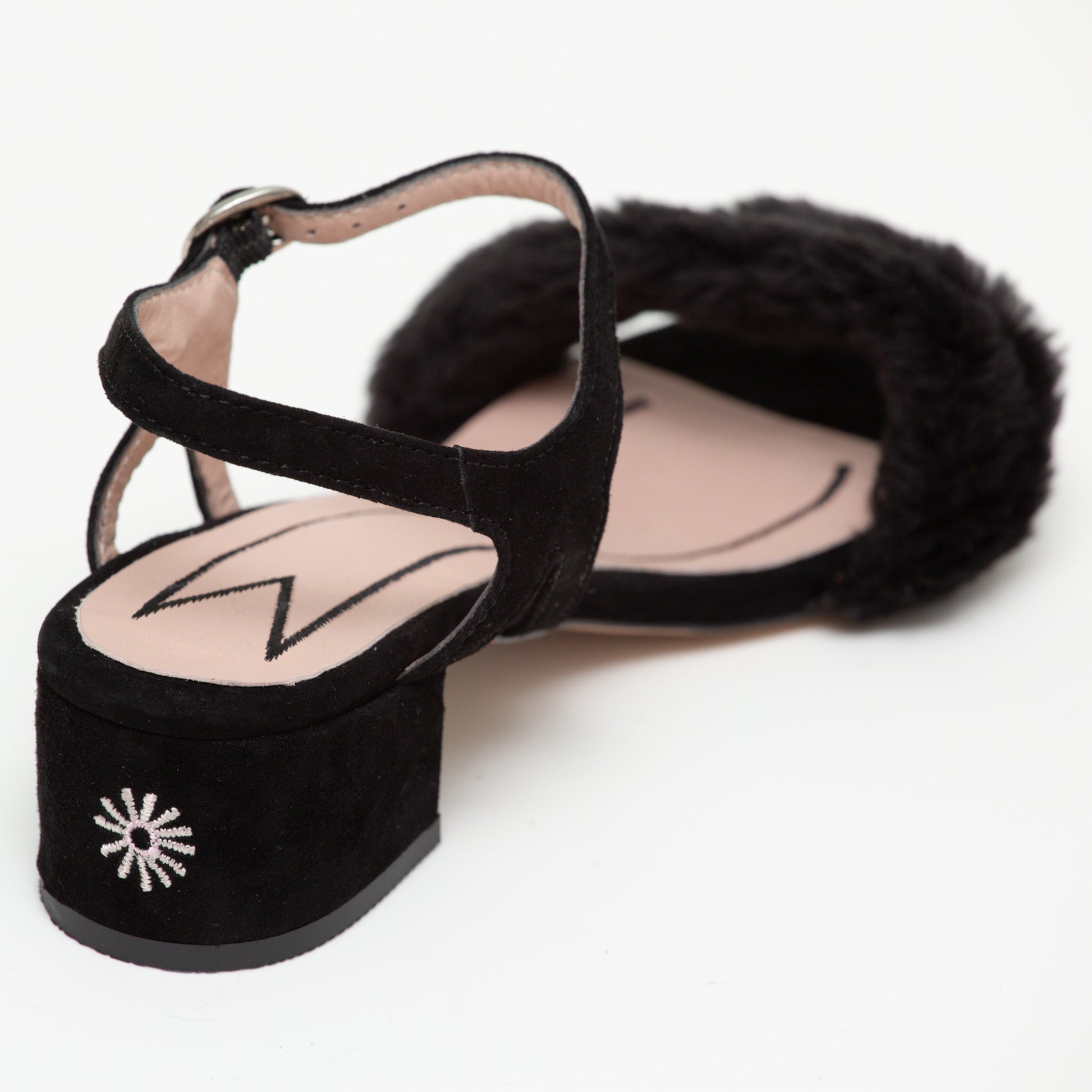 Back of the Zola low sandal shoe showing off the cute cat butt on the heel and the cat outline on pink in the shoe lining.