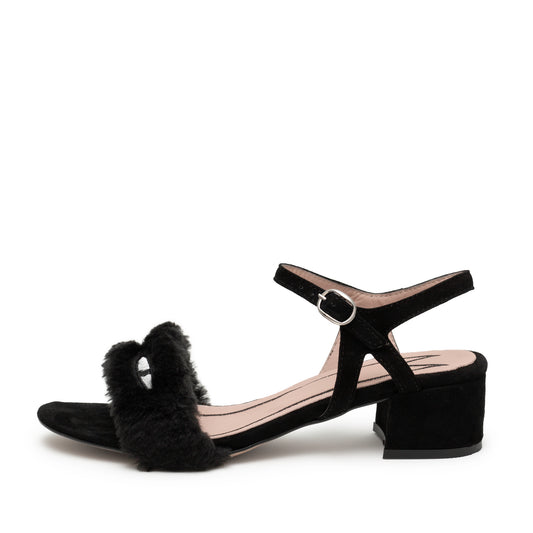 Low heeled black suede open toed sandal with fluffy faux fur upper strap and cat eyes. The ankle strap has a silver clasp.